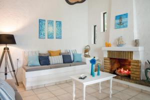 a living room with a couch and a fireplace at Blue Cactus village center in Agia Pelagia +213 photos