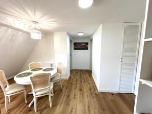 a dining room with a white table and chairs at Pod 20 in Jelenia Góra +5 photos