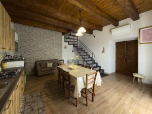 a kitchen and living room with a table and chairs at B&B Vatra in Civita