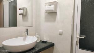 a bathroom with a white sink and a mirror at "Sofia" Guest House in Samarkand