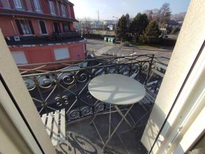a white chair sitting on a balcony with a railing at Jaurès 3 - appart proche gare in La Roche-sur-Foron