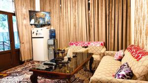 a living room with a couch and a coffee table at "Sofia" Guest House-Hostel in Samarkand
