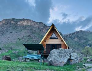 a house with a bench in front of it at Gold Star in Kazbegi