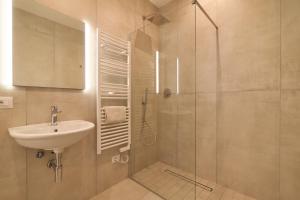 a bathroom with a sink and a glass shower at Suite n12 - Loft incantevole nel cuore di Perugia in Perugia