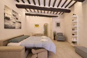 a bedroom with a large bed and a couch at AM12 - Loft incantevole nel cuore di Perugia in Perugia