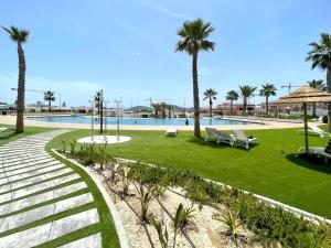 a park with palm trees and a swimming pool at Seascape Luxury Finestrat in Finestrat