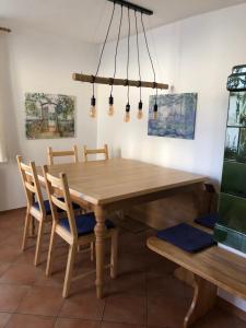 a dining room with a wooden table and chairs at Idyllisches Häusle Teningen in Teningen
