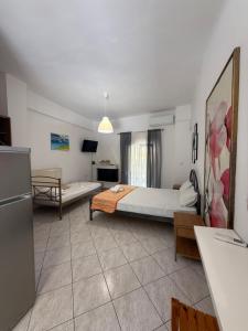 a large room with a bed and a couch at Fiore House in Parga