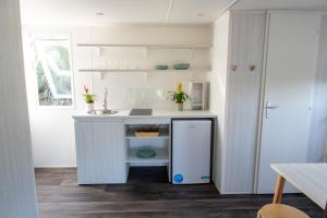 a kitchen with a white counter and a sink at Bungalow Safari 1 in Tarifa