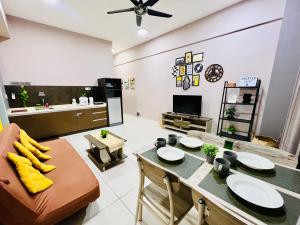 a living room with a table and a couch at M Suite Homestay, Sutera Avenue Kota Kinabalu - Near Imago in Kota Kinabalu