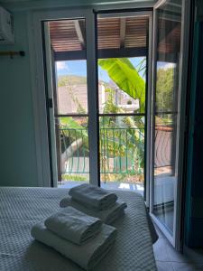 a bedroom with a bed with four pillows on it at Medusa Apartments in Katelios +37 photos