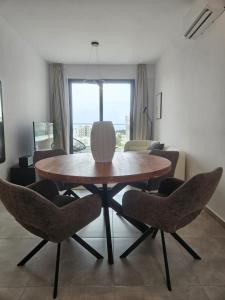 a dining table and chairs in a living room at Sea view Penthouse Universal Residences in Paphos +56 photos