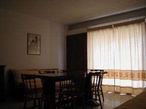 a dining room with a table and chairs and a window at Residence Spiaggia Bianca in Golfo Aranci