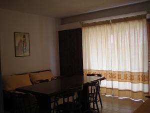 a dining room with a table and chairs and a couch at Residence Spiaggia Bianca in Golfo Aranci