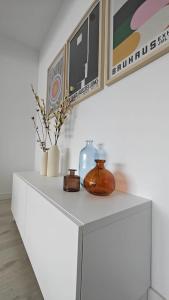a white cabinet with vases and pictures on it at IAROS Pueblo del Sol T1 in Mogro