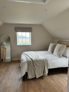 a bedroom with a bed and a window at Natures Loft in Darlington