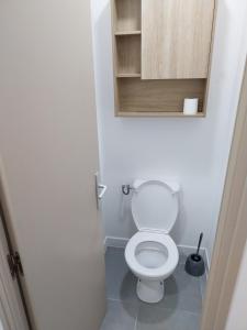 a bathroom with a white toilet and a cabinet at L'étang au soleil in Berre-lʼÉtang +25 photos