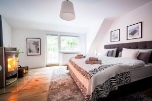 a bedroom with a large bed and a fireplace at Design Apartments Schloss Burg Solingen - BRIGHT Collection in Solingen