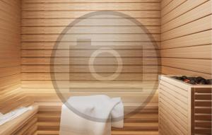 a bathroom with a towel dispenser and a tub at Ferienhauspark Hasselfelde in Hasselfelde