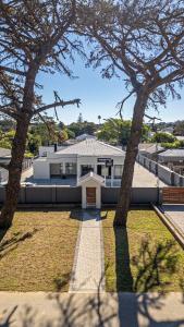 a house with two trees in front of it at Jetsetters in Port Elizabeth