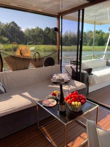 a living room with a couch and a table with a bowl of fruit at Cat Stone in Pisz