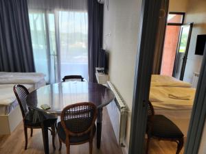 a room with a table and chairs and a bed at Seventh Floor Apartment in Kutaisi