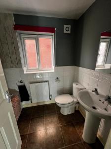 a bathroom with a toilet and a sink at Executive Home in Carlton +18 photos
