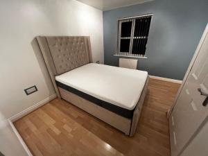 a small bedroom with a bed and a window at Executive Home in Carlton