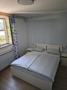 a bedroom with a bed and a window at Apartments Miklus in Portorož