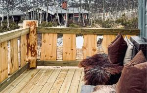 a wooden deck with a bench and pillows at Stunning Home In Beitostølen With Sauna in Beitostøl