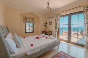 a bedroom with a bed with roses on it at Villa Mandalina, Cukurbag Peninsula-Kas in Kaş +56 photos