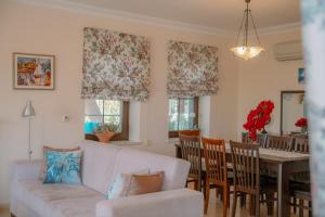 a living room with a couch and a table and chairs at Villa Mandalina, Cukurbag Peninsula-Kas in Kaş