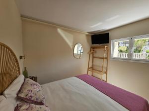 a bedroom with a bed and a window at Casa Peñascales -Laxe- Costa da Morte in Laxe