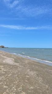 an empty beach with the ocean in the background at Квартира у моря in Baku