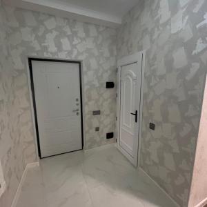 a hallway with a white door and a wall withanimal at Квартира у моря in Baku +15 photos