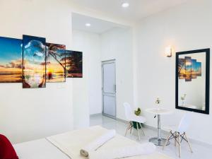 a white room with a white couch and a table at The Silent Gate in Ipitagoda