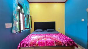 a bedroom with a large bed with a pink blanket at Mahi Restaurant & Guest House in Almora