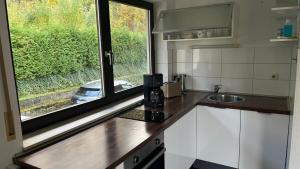 a kitchen with a counter top with a window at Ferienwohnung Engel in Bad Schwalbach