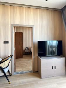 a living room with a large flat screen tv at Grace Hotel in Honiara