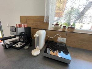 a coffee machine sitting on a counter next to a window at У Максима in Petrovac na Mlavi