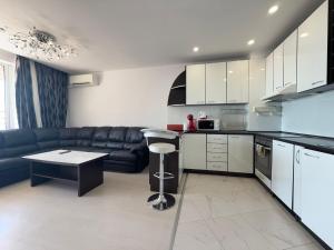 a kitchen with a couch and a table in a room at Golden Tide Residence in Elenite
