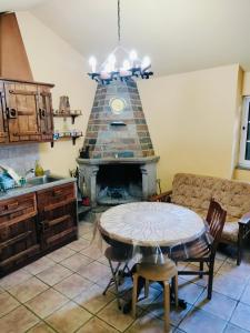 a kitchen with a table and a fireplace at Quinta de Canelas in Torre de Moncorvo