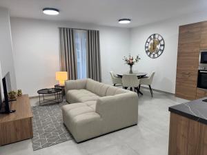 a living room with a couch and a table at Gzira Getaway in Il-Gżira