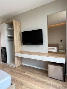 a living room with a tv and a large mirror at Villa Blu in Vlorë +53 photos