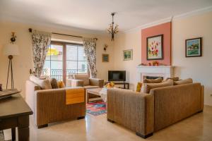 a living room with two couches and a fireplace at Villa Limon, Cukurbag Peninsula-Kas in Kaş