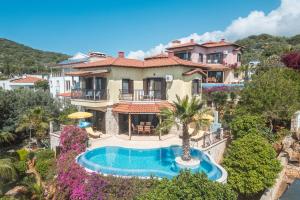 an aerial view of a house with a swimming pool at Villa Limon, Cukurbag Peninsula-Kas in Kaş