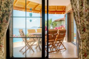 a room with a view of the ocean through a window at Villa Limon, Cukurbag Peninsula-Kas in Kaş