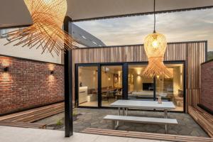 a patio with a bench and a table in a building at Borgraaf - Palazzio in Borgloon