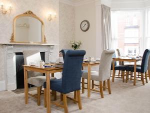 a dining room with a table and chairs and a mirror at Rosslyn House in Whitby