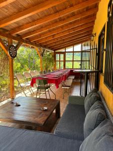 a patio with a long table and chairs and a table sidx sidx sidx at Vikendica Dora in Petrovaradin